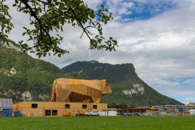 Mollis, Switzerland - August 29. 2025: The big wooden cow (21 meter hight)  at the Swiss Wrestling and Alpine Festival, which is the most traditional national sport festival held every three year in Switzerland