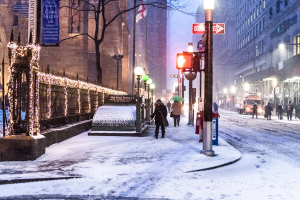 NEW YORK-JANUARY 4: Pedestrians at the break of dawn on Wall St during the bomb cyclone snow storm on January 4 2018 in lower Manhattan.