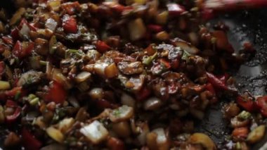 Sebzeleri spatulayla tavada kızart. Sağlıklı yiyecekler, sebzeler tavada kızartılır. Domates patlıcanlı soğan biberli kabak fesleğeni. Buhar