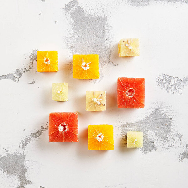 Fresh Citrus Fruits - Cube Slice of Orange, Grapeftuit and Lime. Creative Summer Fruits Layout. Top View