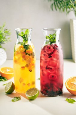 Fresh Homemade Berry and Fruit Citrus Sangria with Wine, Raspberry, Cranberry, Strawberry, Mint and Ice. Refreshment Fruits and Berries Iced Tea, Cocktail, Punch or Compote in Tall Bottles clipart