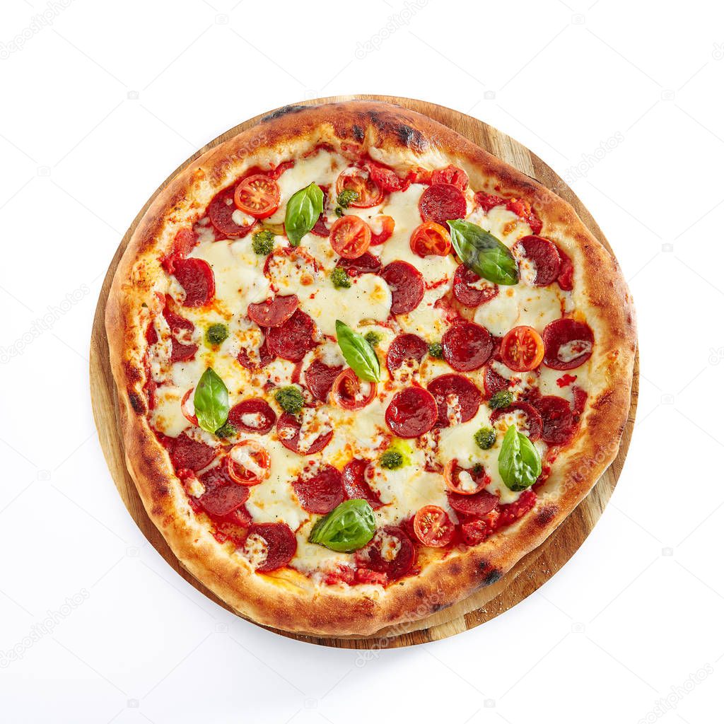 Pepperoni or Diabola Pizza with Salami, Chili Pepper, Mozzarella Cheese, Fresh Basil, Cherry Tomatoes, Tomato Sauce Isolated on White Background. Traditional Italian Flatbread on Wood Plate Top View