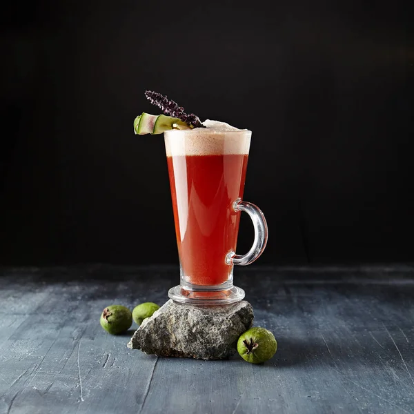 Red Cocktail with White Wine, Bee Honey and Sweet Syrup on Natural Dark Stone Background. Macro Photo of Sweet Pink Alcohol Drink with Fruits, Berries and Cucumber Close Up