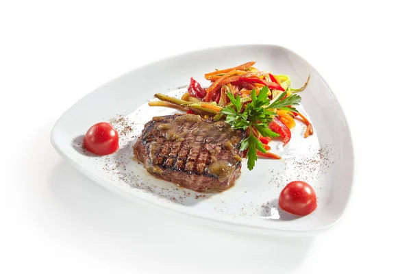 Luxury Serving Dish of Grilled Beef Steak with Vegetables Isolated on White Background. Restaurant Main Course with Barbecue Veal Meat or Beefsteak on Elegant Flat Plate with Greens Close Up