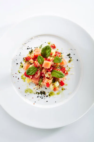 Restaurant Starter Menu with Raw Salted Salmon Slices, Tomato and Cucumber Isolated on White Background. Diced Red Fish or Trout with Vegetables, Herbs and Spices on Elegant Flat Plate Top View — Stock Image Restaurant Starter Menu Raw Salted Salmon Slices Tomato Cucumber Isolated Stock Picture
