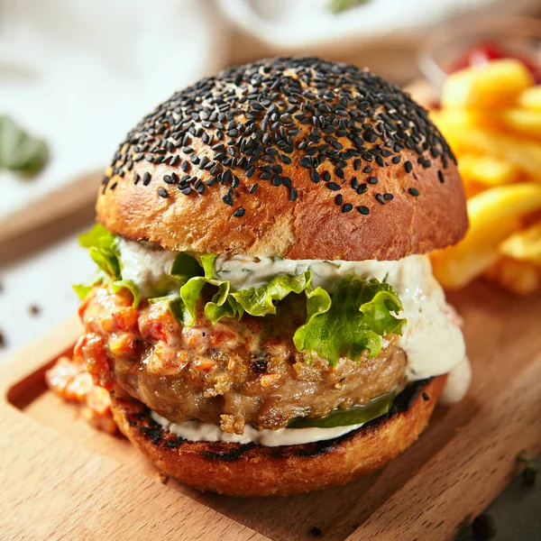 Crispy burger served on wooden board — Stock Photo, Image