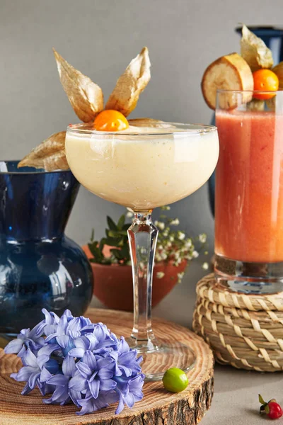 Almond Cream Smoothie in Tall Dessert Glass on Wooden Plate