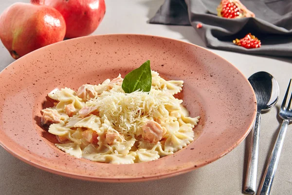 Farfalle Pasta Al Dente with Salmon in Cream Sauce on Rustic Pla — Stock Image Farfalle Pasta Al Dente with Salmon in Cream Sauce on Rustic Pla Royalty Free Stock Photos