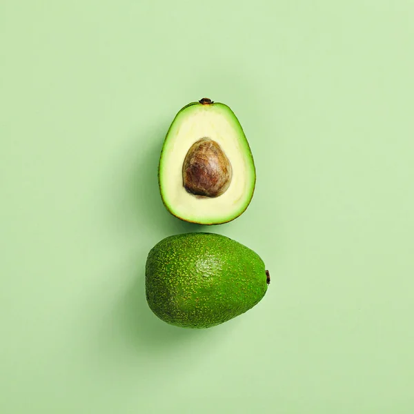 Slices of avocado on color background