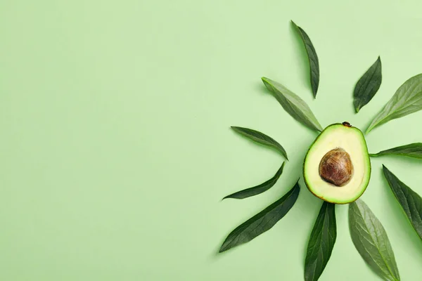 Slices of avocado on color background