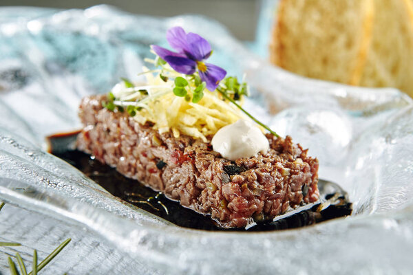 Steak Tartare (Raw Beef) with Sauce on Glass Plate