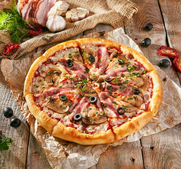 Pizza Restaurant Menu - Delicious Fresh Pizza with Bacon and Mushrooms. Pizza on Rustic Wooden Table with Ingredients