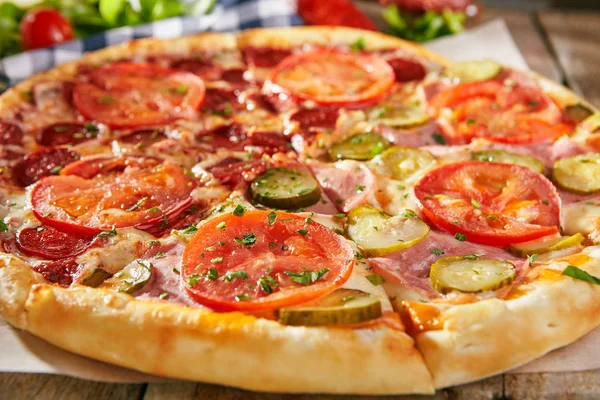 Pizza Half Salami Another Ham Pickled Cucumbers Tomatoes Sliced Wooden — Stock Photo, Image