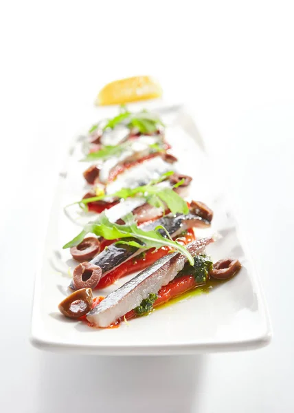 Sardines with tomatoes and kalamata olives — Stock Photo, Image