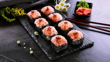 Karides ve masago havyar kapaklı fırında rulo. Geleneksel suşi restoranı menüsü. Ulusal Japon mutfağı aperatifi. Lezzetli oryantal atıştırmalıklar, ahşap tabakta gurme deniz ürünleri.