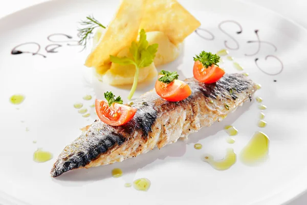 Exquisite serving grilled mackerel with mashed potatoes and toma