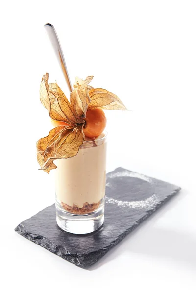 Cheesecake in high glass decorated with physalis — Stock Photo, Image