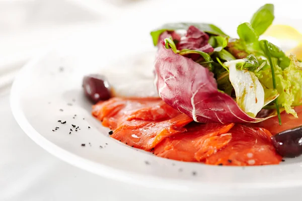 Gourmet, restaurant, delicious dinner food - close up of Fish Dish with Lemon and Fresh Basil Leaves