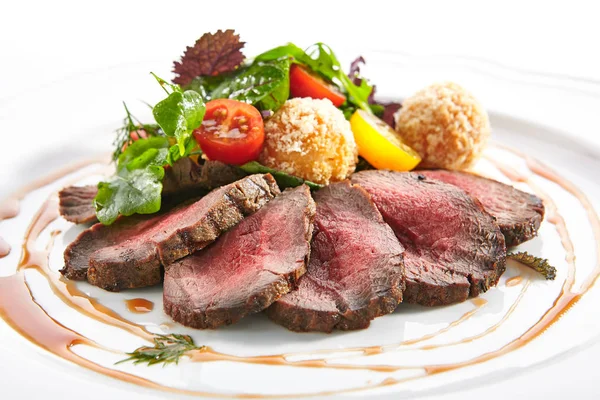 Medium Rare Roast Beef with Green Mix and Potato Balls Stock Picture