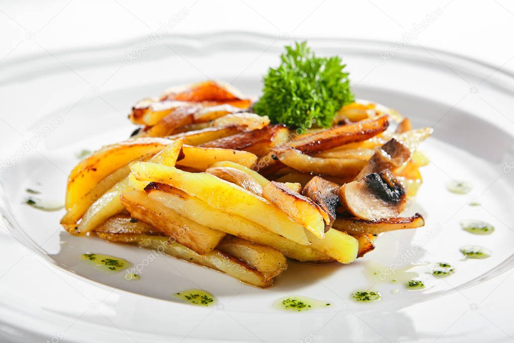 Fried Potatoes with Mushrooms on a Restaurant Plate Isolated