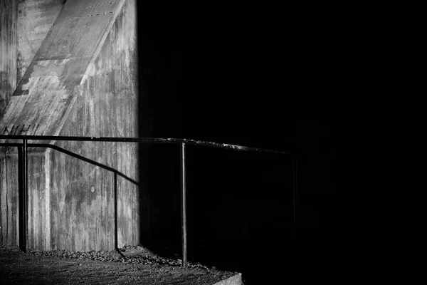 Shadow and light on concrete with an old handrail as a line with shadow.