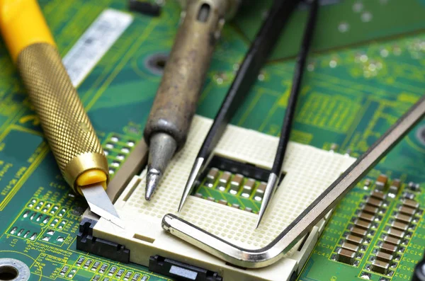 Close up of tools on the motherboard of the laptop