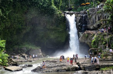 BALI, INDONESIA- 14 FEB, 2019: Tourist visiting the Tegenungan waterfall in Bali, Indonesia. Tegenungan Waterfall is a great stopover for nature lovers clipart