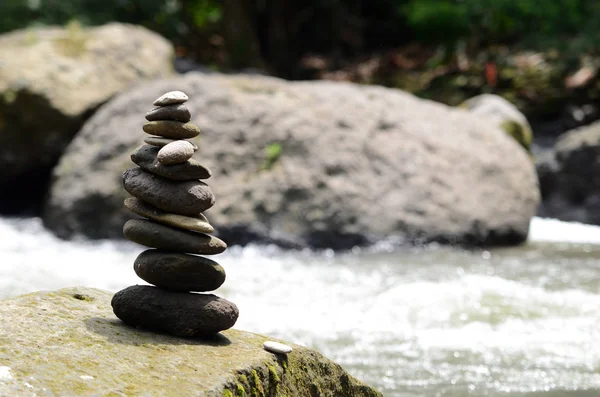 Stacked zen stone at Tegenungan Waterfall — Stock Photo, Image
