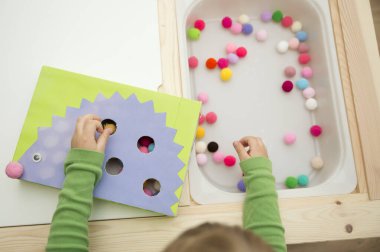 Kirpi. Küçük çocuklar için oyun düzenleme. Çukurları ponponlarla doldurun. Erken eğitim, renk öğrenme ve sayısallık. Montessori anaokulu ve özel ihtiyaçlar okulu için temalı uygulama