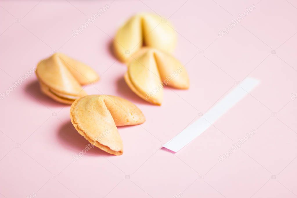 fortune cookie on pink and blue background, pastel colors, copy space for prediction