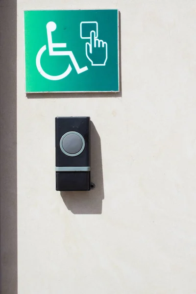 Call button for the disabled personnes. Door opener button on the wall for disabled people.