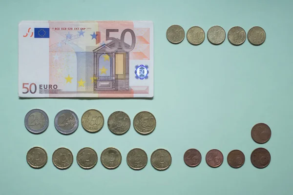 banknotes 50 euros, Euro coins and Euro cents on the green background