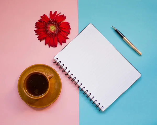 minimalist Flat lay, pastel colors, gerbera, Cup, notebook, pen, copy space