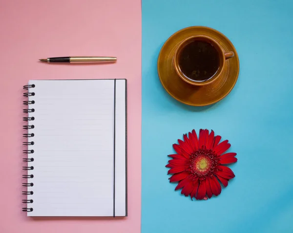 minimalist Flat lay, pastel colors, gerbera, Cup, notebook, pen, copy space