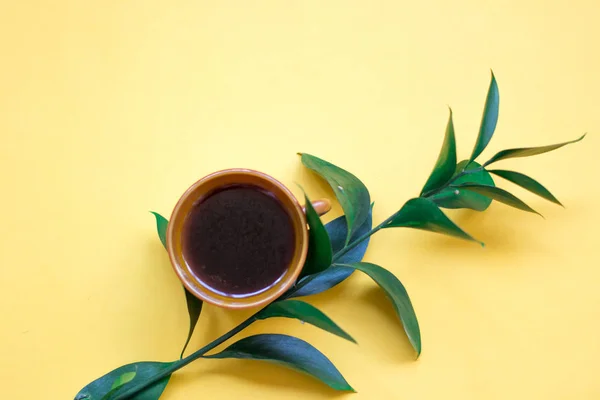 Minimalist Flat Lay Yellow Background Cup Coffee Green Branch — Stock Photo, Image