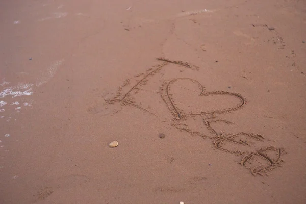 inscription I love sea on the beach sand