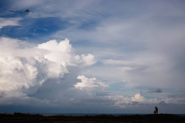 kite and Cumulus clouds and sun in the sky