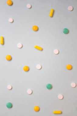 Beyaz, yeşil ve turuncu hap ve tabletler üzerinde mavi bir arka plan deseni. Çeşitli ilaç tıp hapları, düz yatıyordu