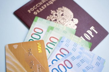 Moscow, Russia- 08 28 2018: Russian passport. The Russian Currency, including the new 2000 ruble-denominated promissory notes. The MIR credit cart clipart