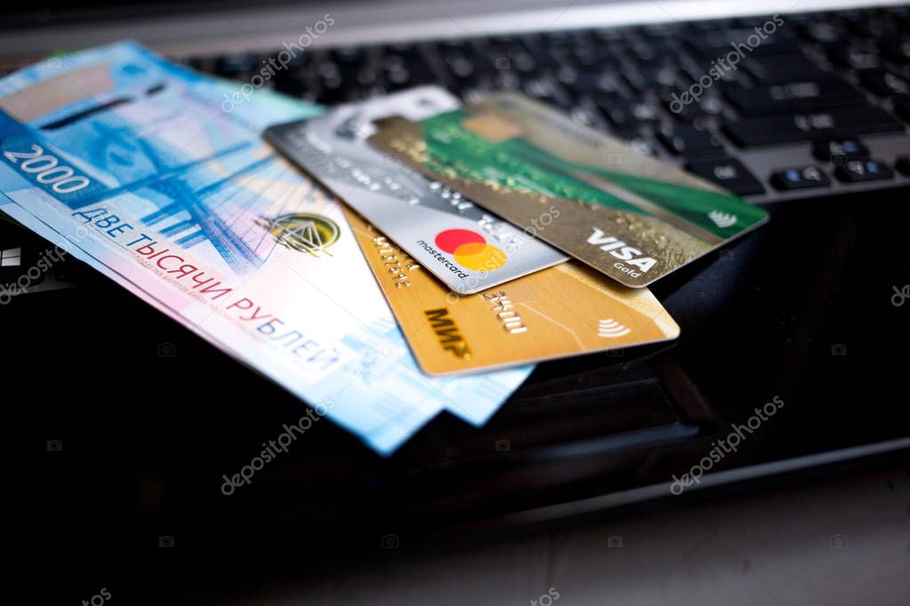 MOSCOW, RUSSIA - 08 28 2018: banknotes Russian rubles and credit cards are on the laptop keyboard
