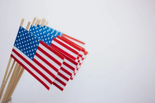 Miniature paper flags USA. American Flag on white background.