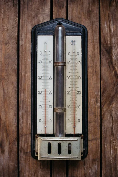 ancient thermometer on wooden background, 26 degrees Celsius