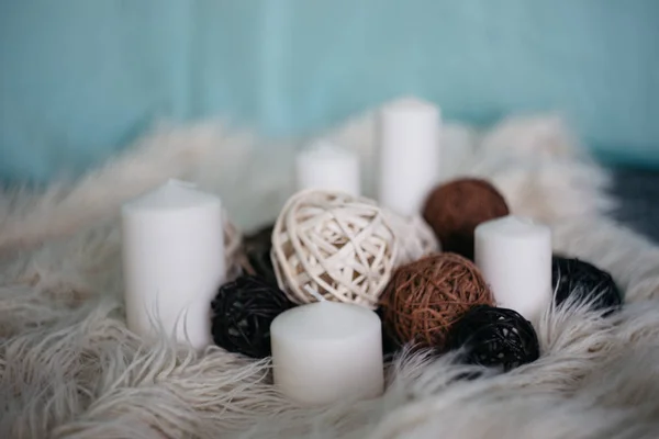 white candles and decor items on a carpet