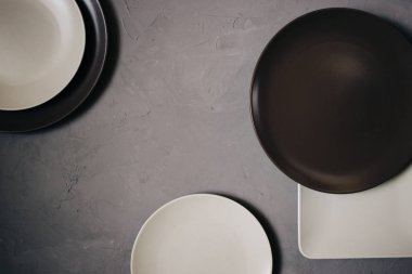 Set seramik tabak kahverengi ve sütlü beyaz renkli, gri arka plan üzerinde yukarıdan