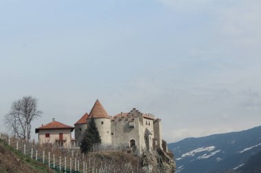 Cave, Italy - 03 20 2013: view of the Alpine highway, fortress, traffic, mountains. Italian villages