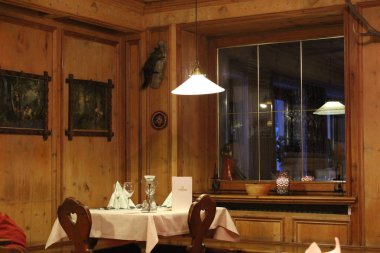 Stelvio, Italy - 03 20 2013: restaurant interior, decor, flowers by the window, Alpine restaurant