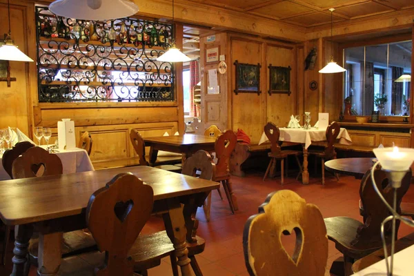 Stelvio, Italy - 03 20 2013: restaurant interior, decor, flowers by the window, Alpine restaurant