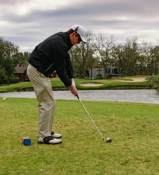 Любитель гольфа фокусируется на своем мяче на поле для гольфа — стоковое фото