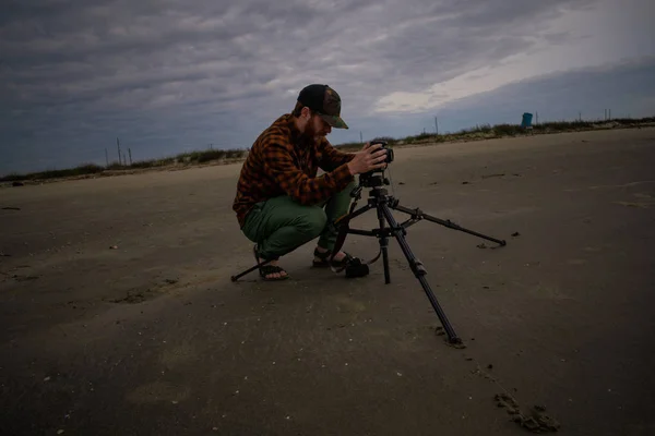 Fotógrafo de playa usando un trípode para disparar olas y Bay Sky —  Fotos de Stock