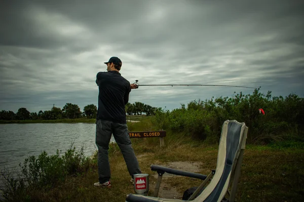 Fisherman in action Standing Up Casting — стоковое фото